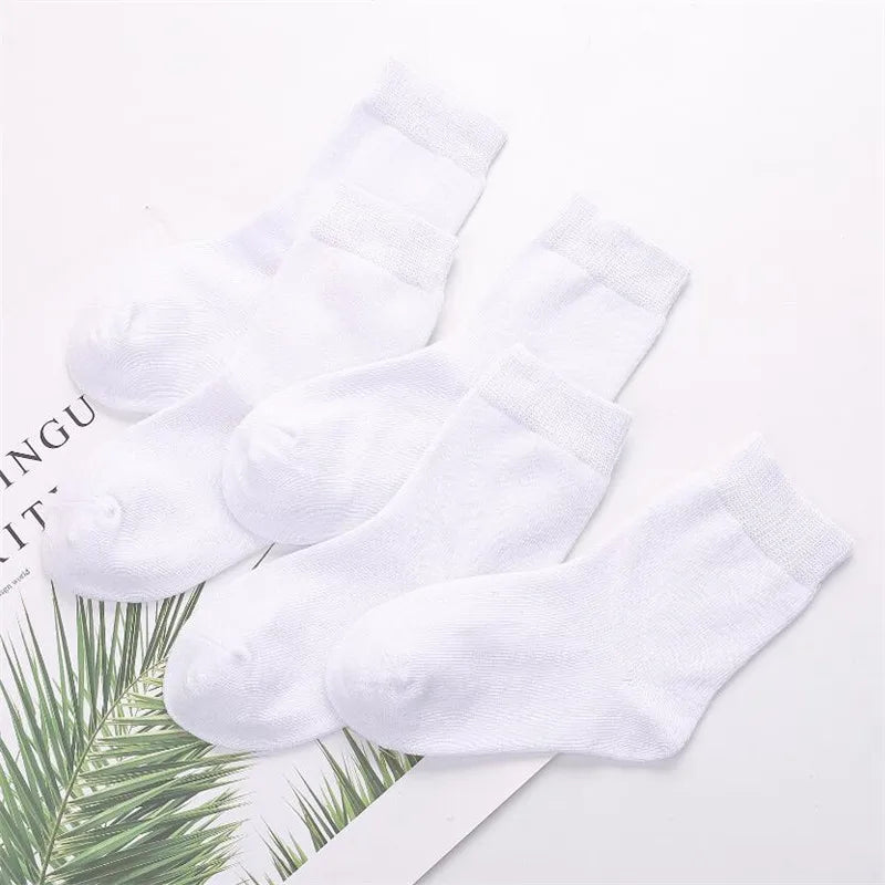 White socks on a white surface with green leaves and text in the background