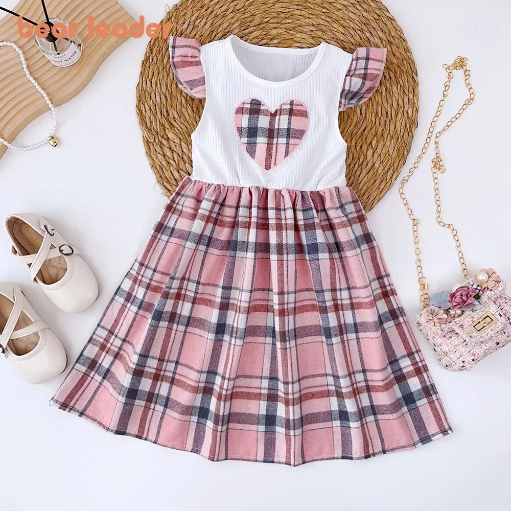 Children's dress with plaid skirt and heart design on a white background