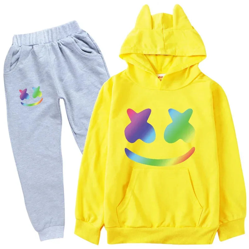 Yellow hoodie with colorful smiley face design and gray pants with smiley face design on a white background