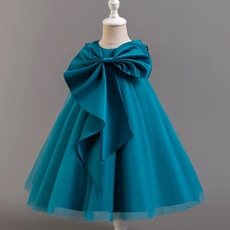 Teal dress with a large bow on a mannequin against a gray background
