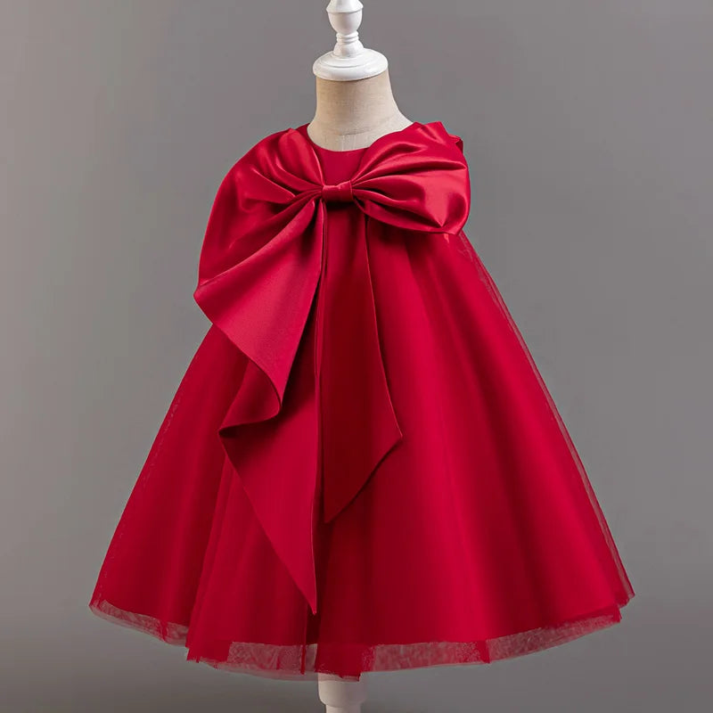 Red dress with a large bow on a mannequin against a gray background