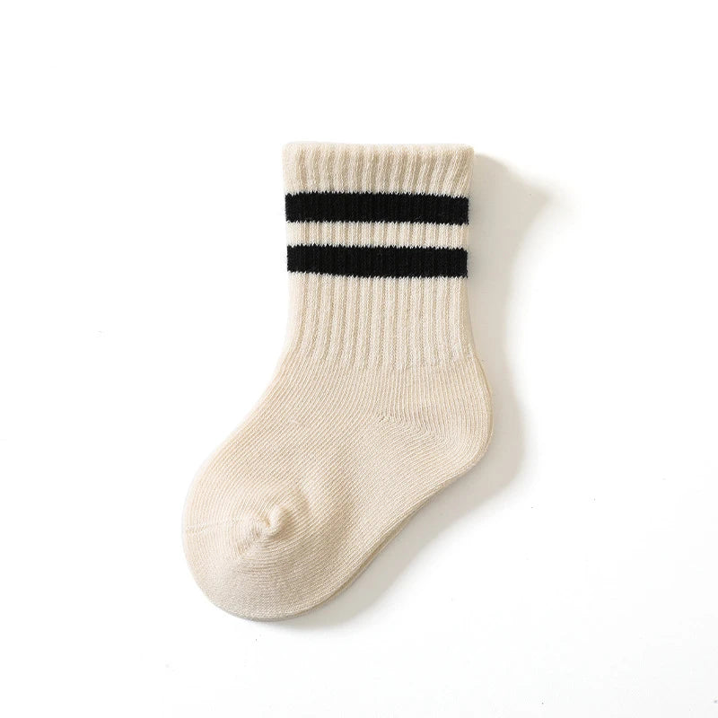 Beige sock with black stripes on a white background