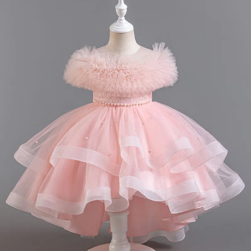 Pink children's dress on a mannequin against a gray background