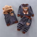 Children's clothing set with bear designs on a gray background