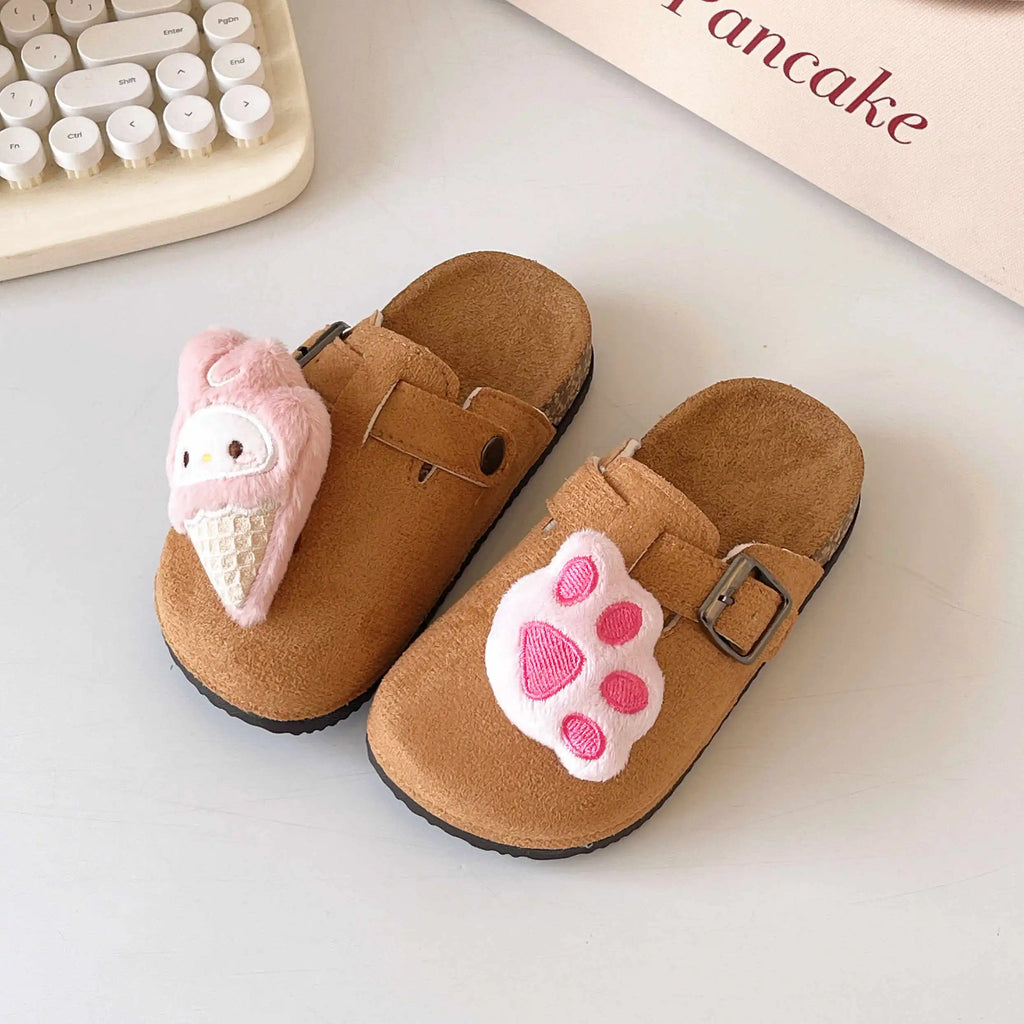 Brown slippers with pink ice cream and paw print design on a light surface.