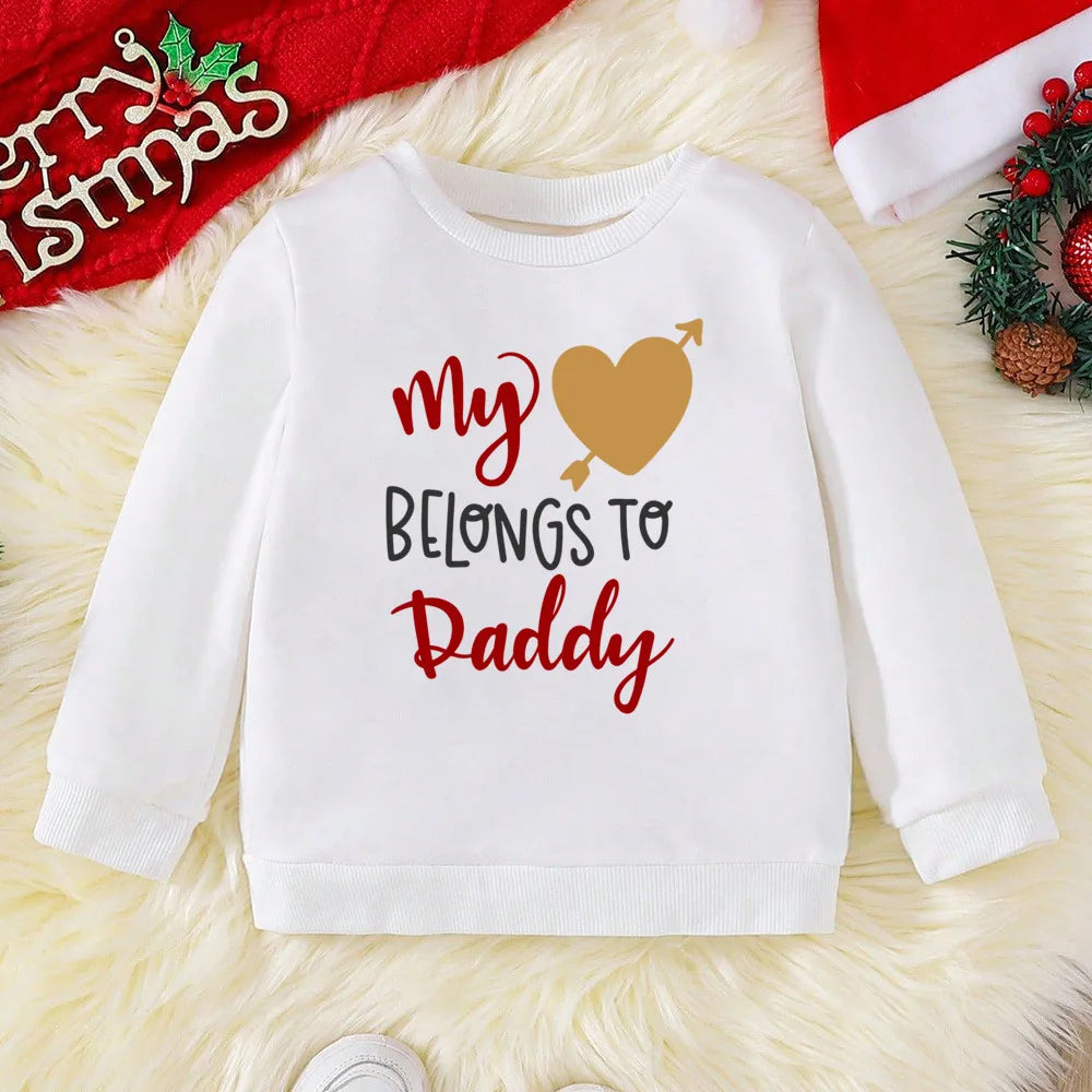 White sweatshirt with 'My Heart Belongs to Daddy' text on a festive background