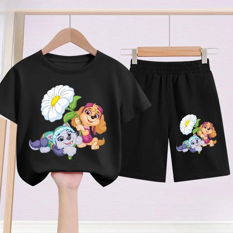 Black t-shirt and shorts set with cartoon characters and flowers on a hanger against a white background.