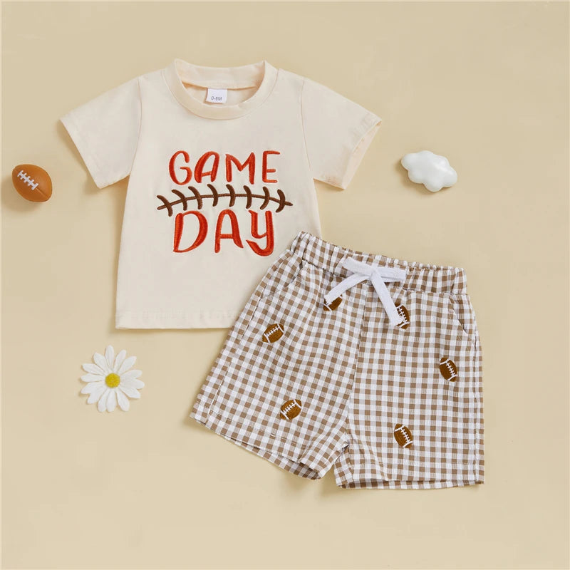 Children's outfit with 'Game Day' t-shirt and checkered shorts on a beige background