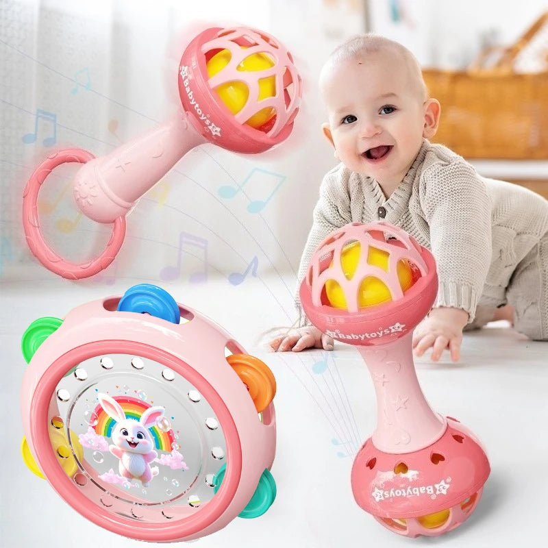 Baby playing with colorful rattles on a light background