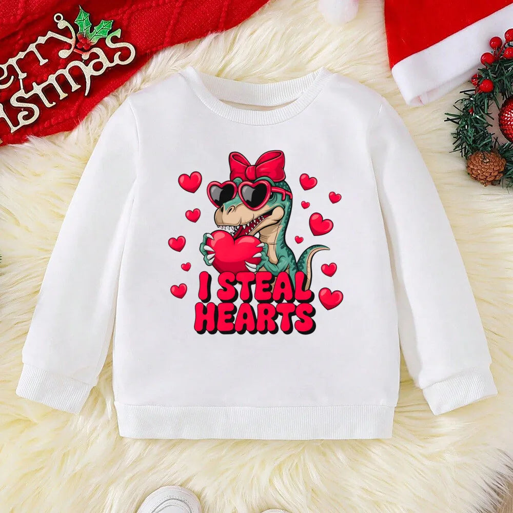 White sweatshirt with a dinosaur graphic and 'I Steal Hearts' text on a textured surface.