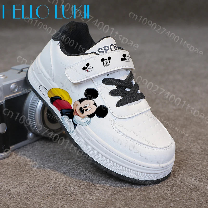 White children's shoe with cartoon character design on a textured surface