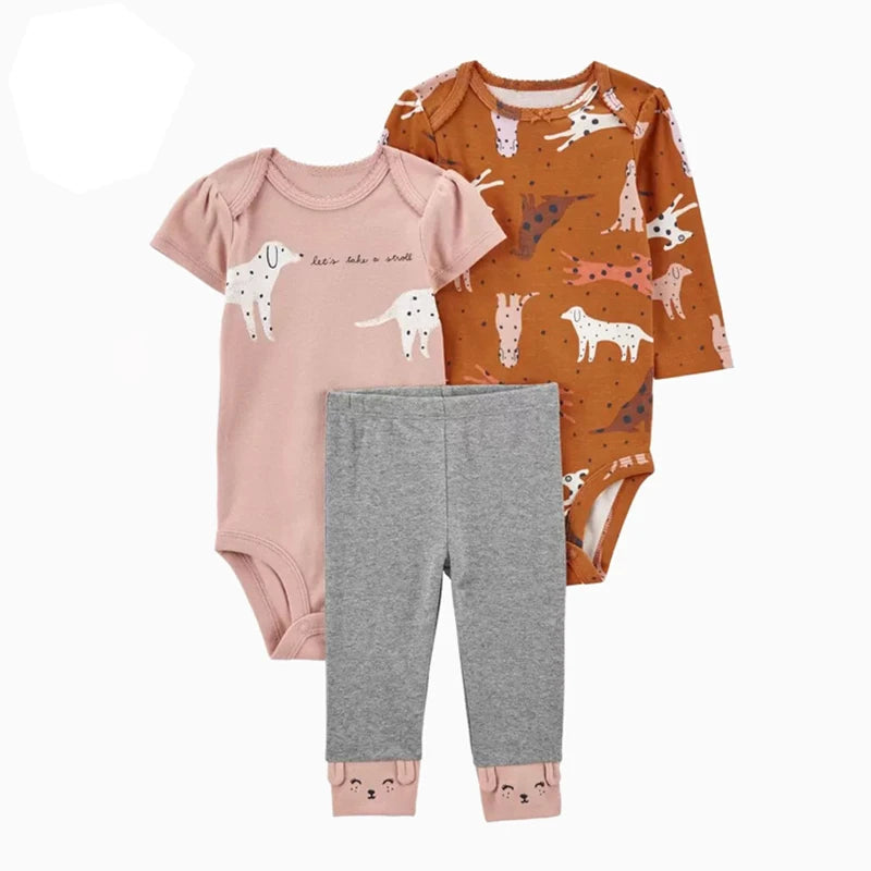Baby outfit set with pink bodysuit, gray pants, and orange long-sleeve shirt with dog pattern on a white background.