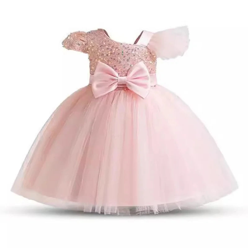 Pink children's dress with a large bow on a white background