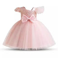 Pink children's dress with a large bow on a white background