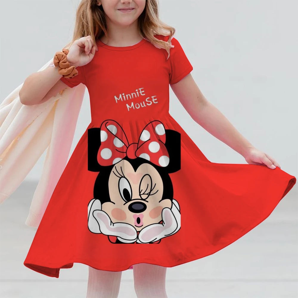 Child wearing a red Minnie Mouse dress against a plain background