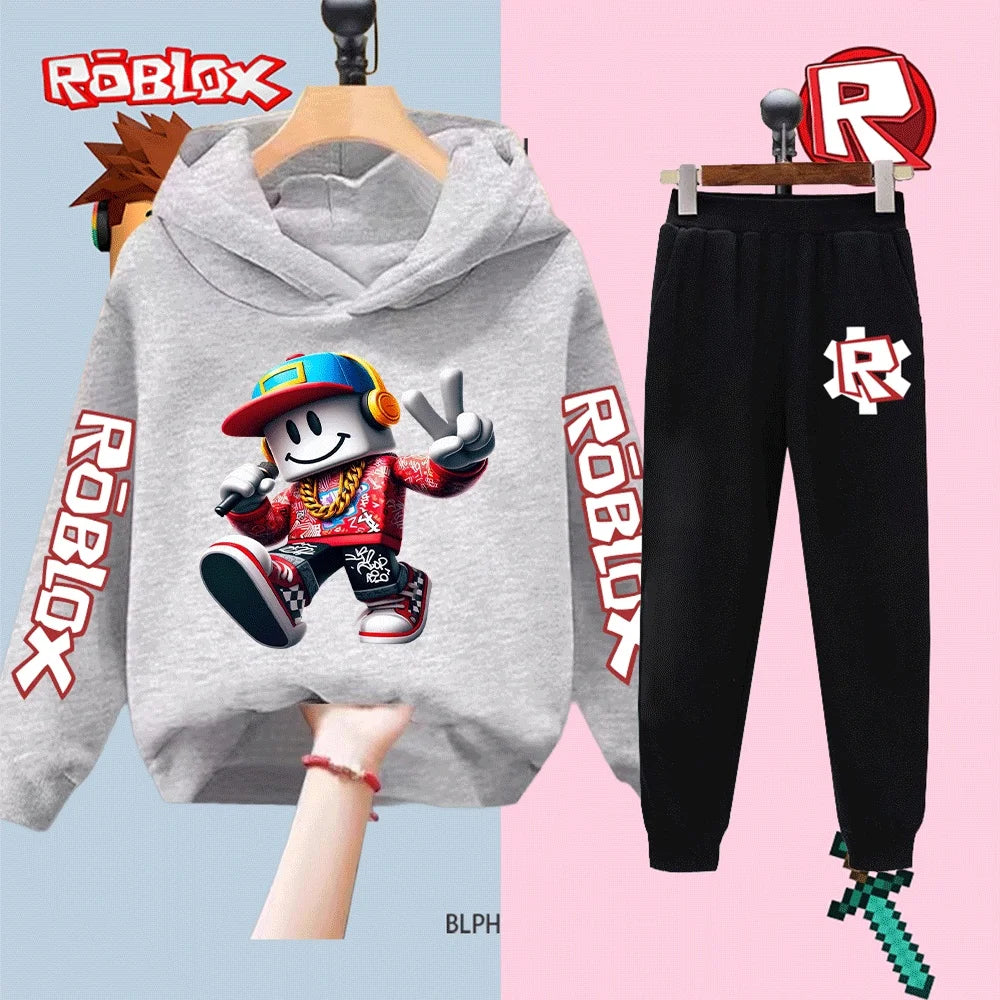 Gray hoodie with Roblox character design and black pants with Roblox logo on a split background.