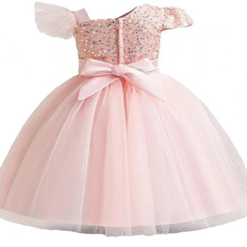 Pink dress with sequin top and bow on a white background