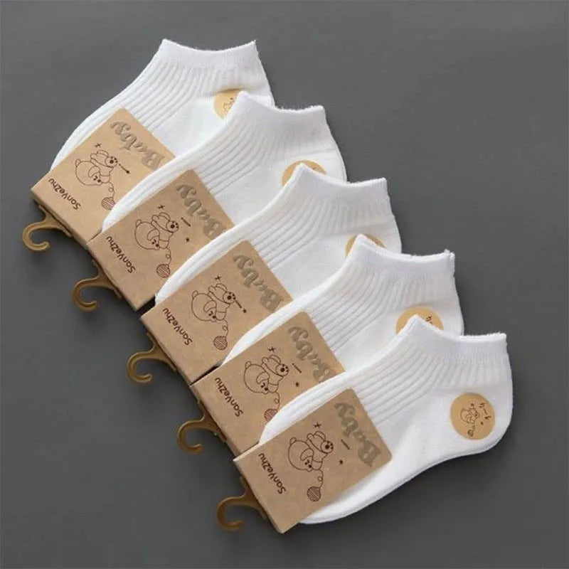 Set of white socks with brown packaging on a gray background