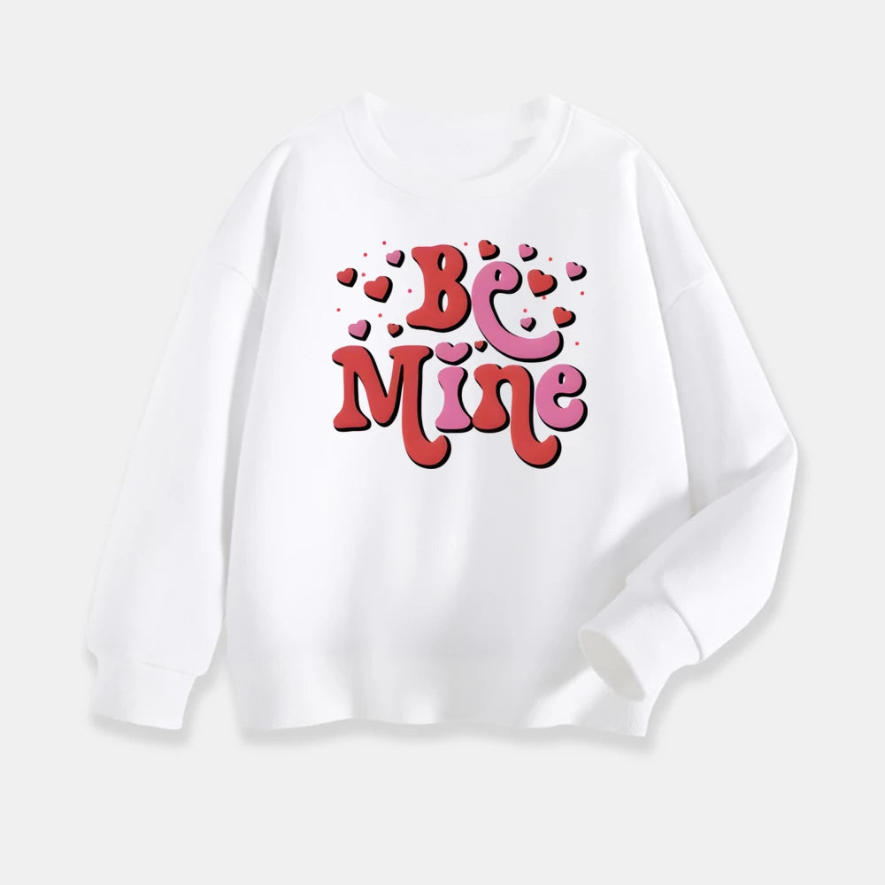 White sweatshirt with 'Be Mine' text and heart designs on a white background