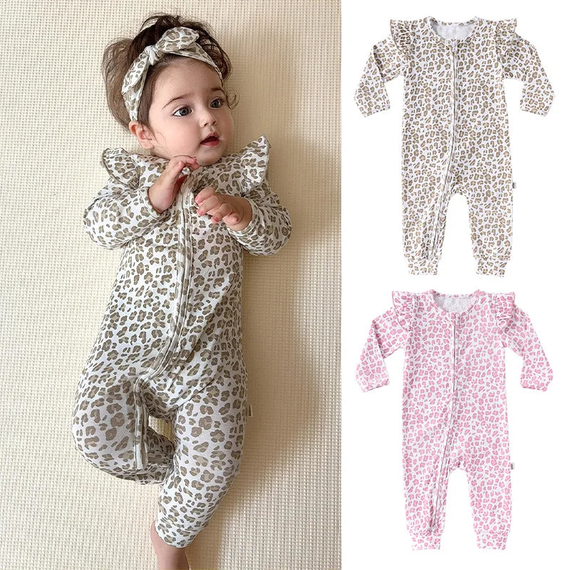 Baby in a leopard print onesie with two additional onesies shown on the right.