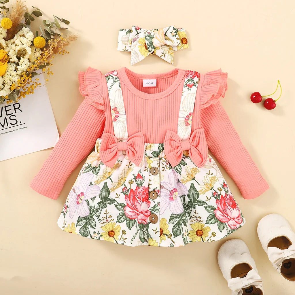 Children's outfit with pink top, floral skirt, headband, and shoes on a beige background.