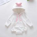 White baby onesie with pink accents on a white background