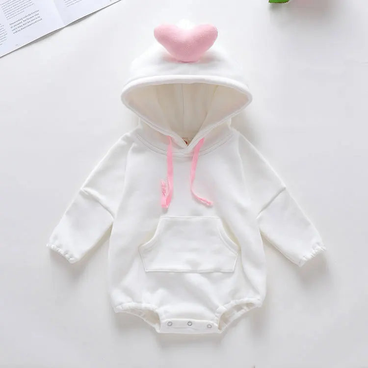 White baby onesie with pink accents on a white background