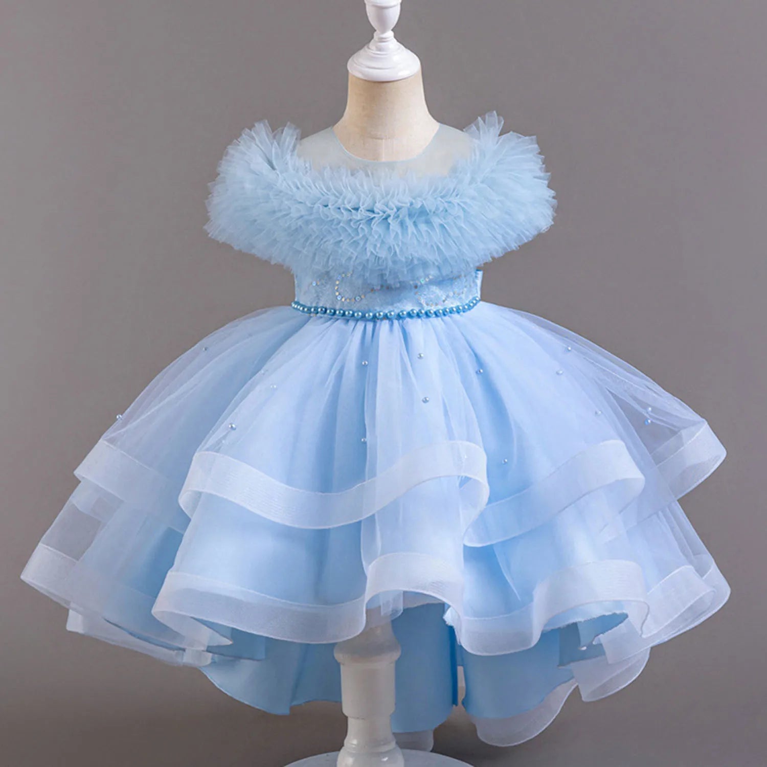 Light blue dress on a mannequin against a gray background