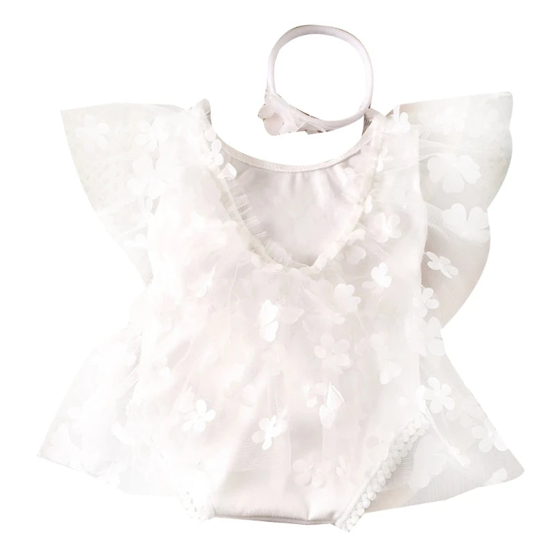 White baby dress with ruffled sleeves on a white background