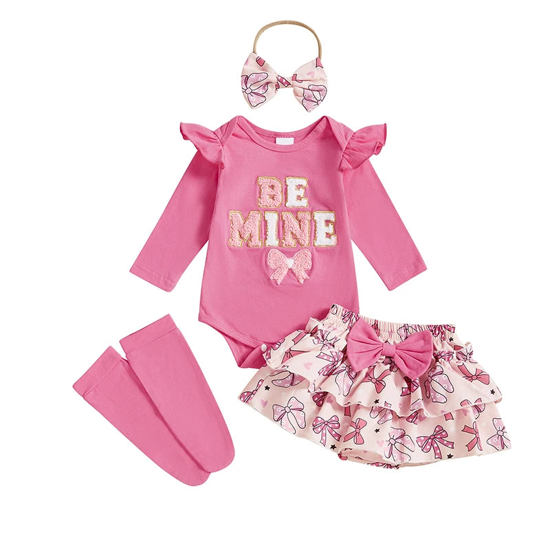 Pink baby outfit with 'Be Mine' shirt, skirt, headband, and leg warmers on a white background