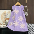 Purple dress with floral designs on a hanger against a wooden wall.