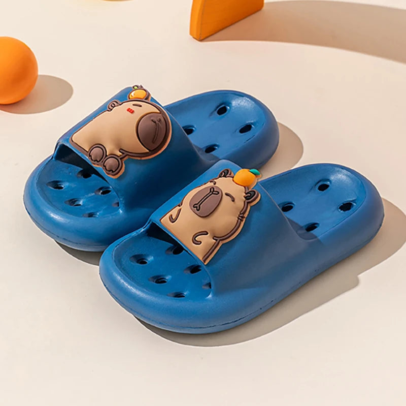Blue children's sandals with cartoon bear faces on a light background