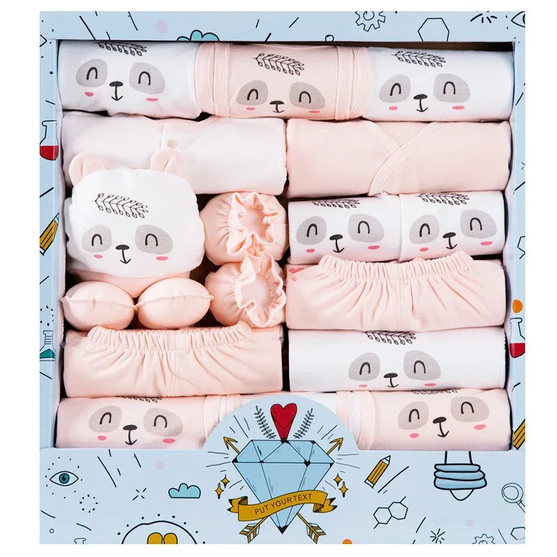 Set of pink baby clothes with bear face designs in a decorative box.