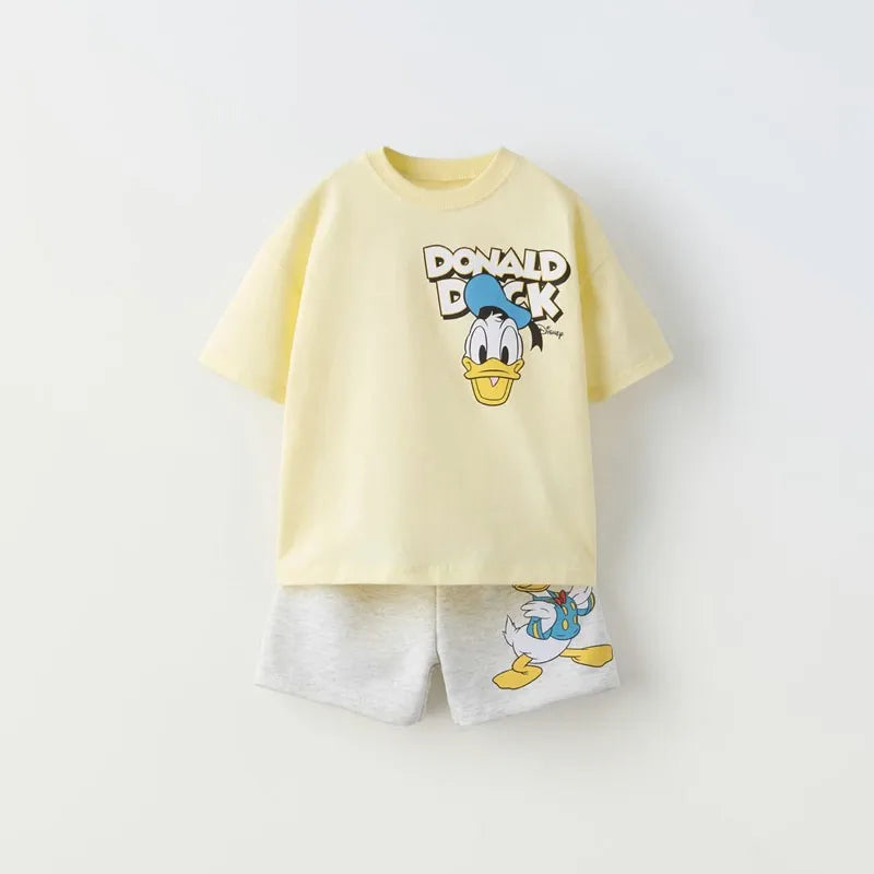 Yellow t-shirt and shorts set with Donald Duck design on a light gray background