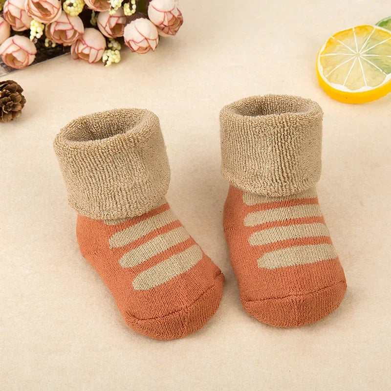 Pair of baby socks with striped design on a light background