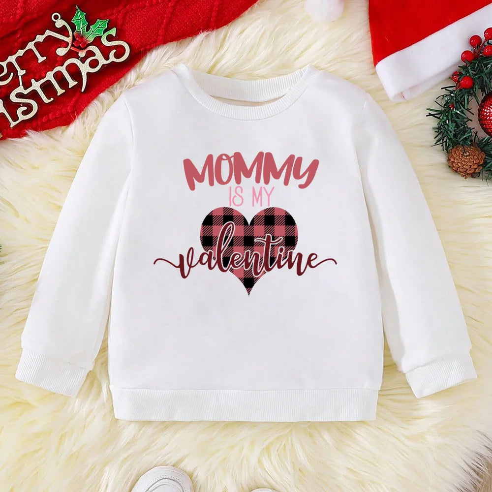 White sweatshirt with 'Mommy is my Valentine' text on a festive background