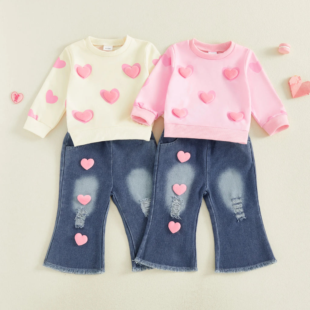 Two children's outfits with heart patterns on a light background