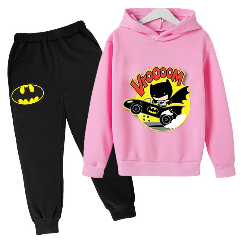 Pink hoodie with cartoon character and black pants with Batman logo on a white background