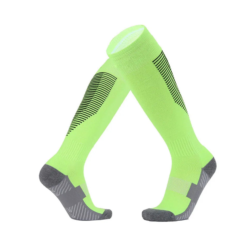 Pair of green knee-high socks with black patterns on a white background