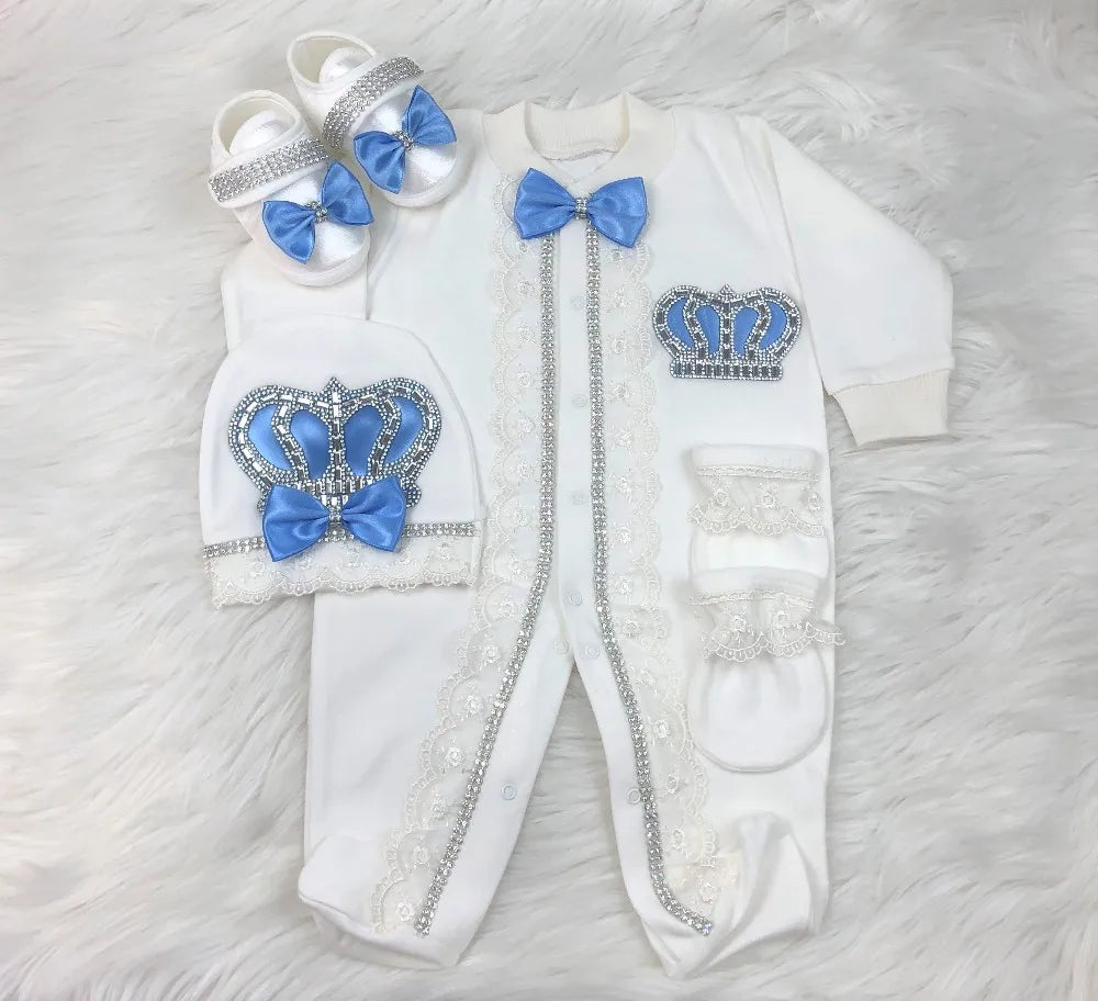 Baby outfit set with blue crowns and bows on a white background