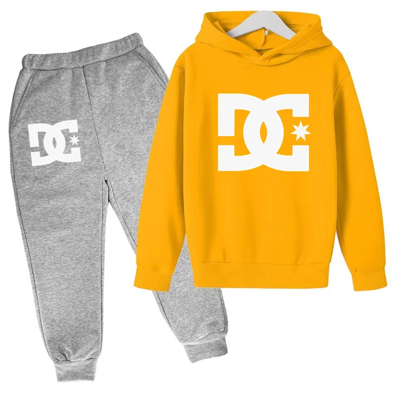 Yellow hoodie and gray sweatpants with DC logo on a white background