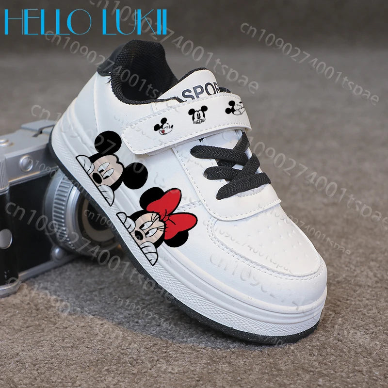 White children's shoe with cartoon character design on a textured surface