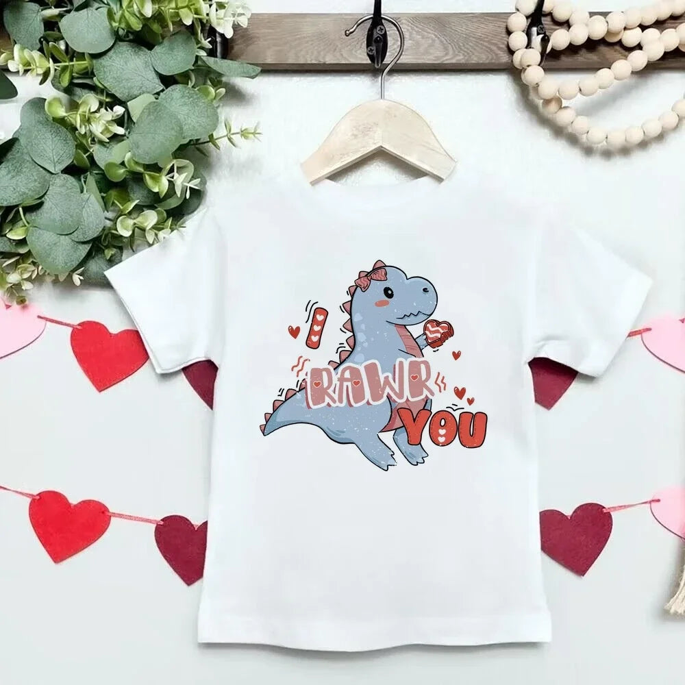 White t-shirt with a dinosaur graphic and 'RAWR YOU' text on a white background with heart decorations.