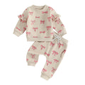 Children's outfit with pink bow pattern on a beige background
