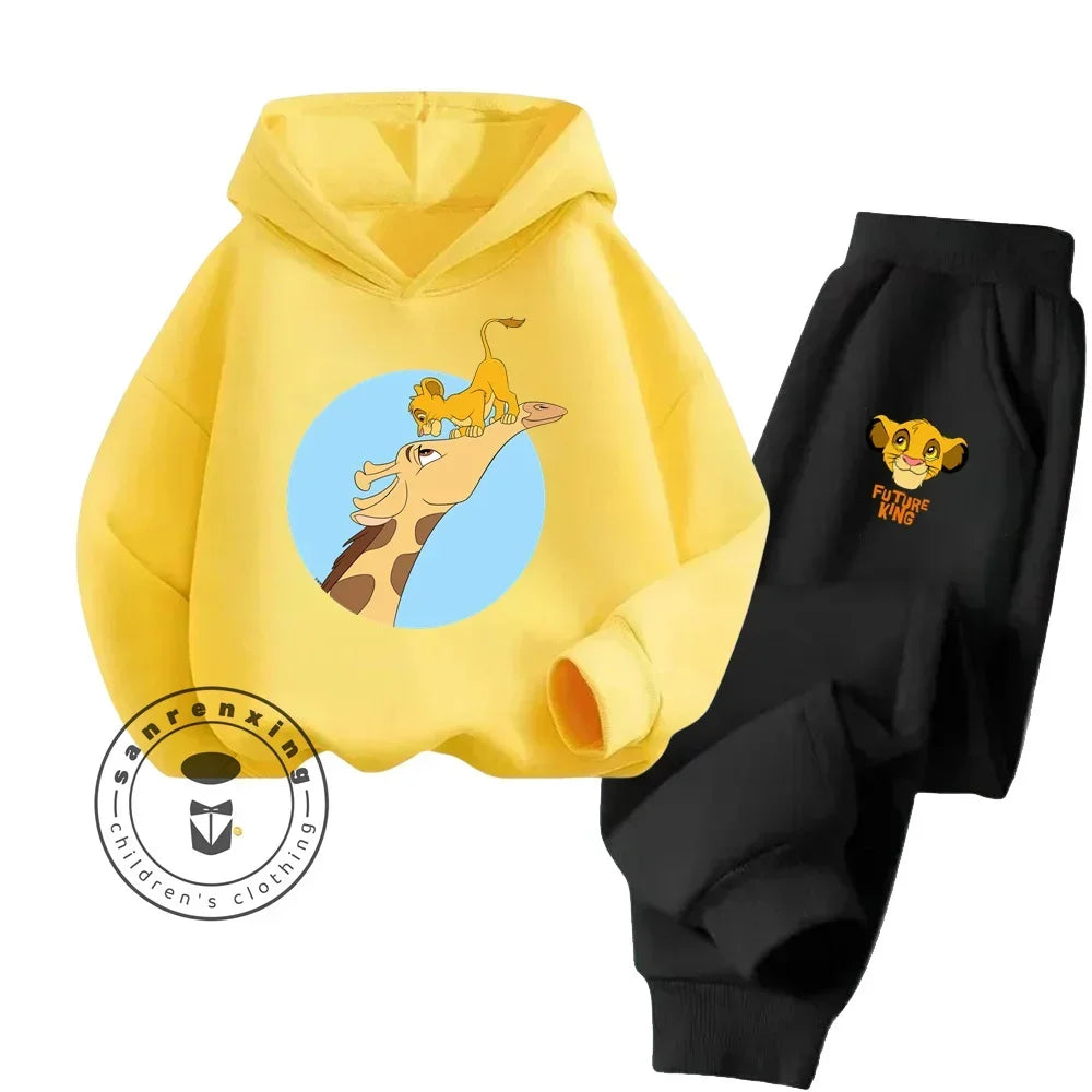 Yellow hoodie with cartoon design and black pants with logo on a white background