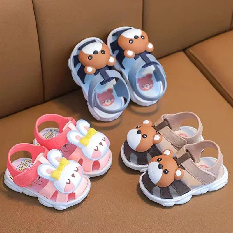 Set of children's sandals with cartoon character designs on a brown surface.
