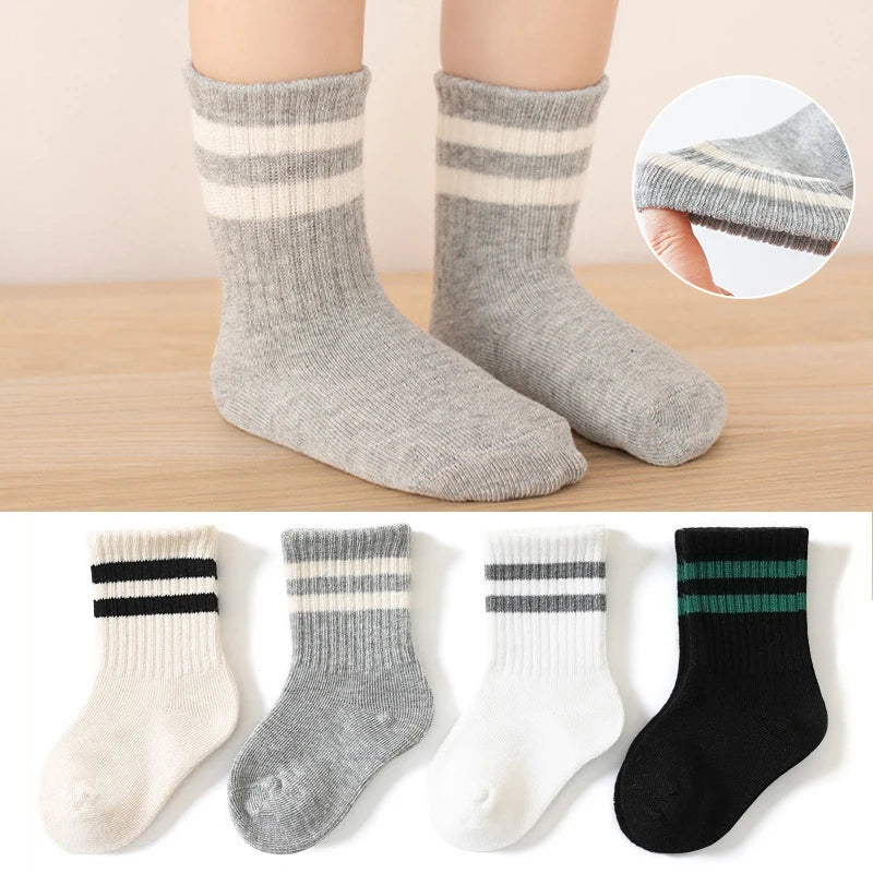 Gray socks with white and black stripes worn by a person, with close-up inset and additional pairs displayed below.