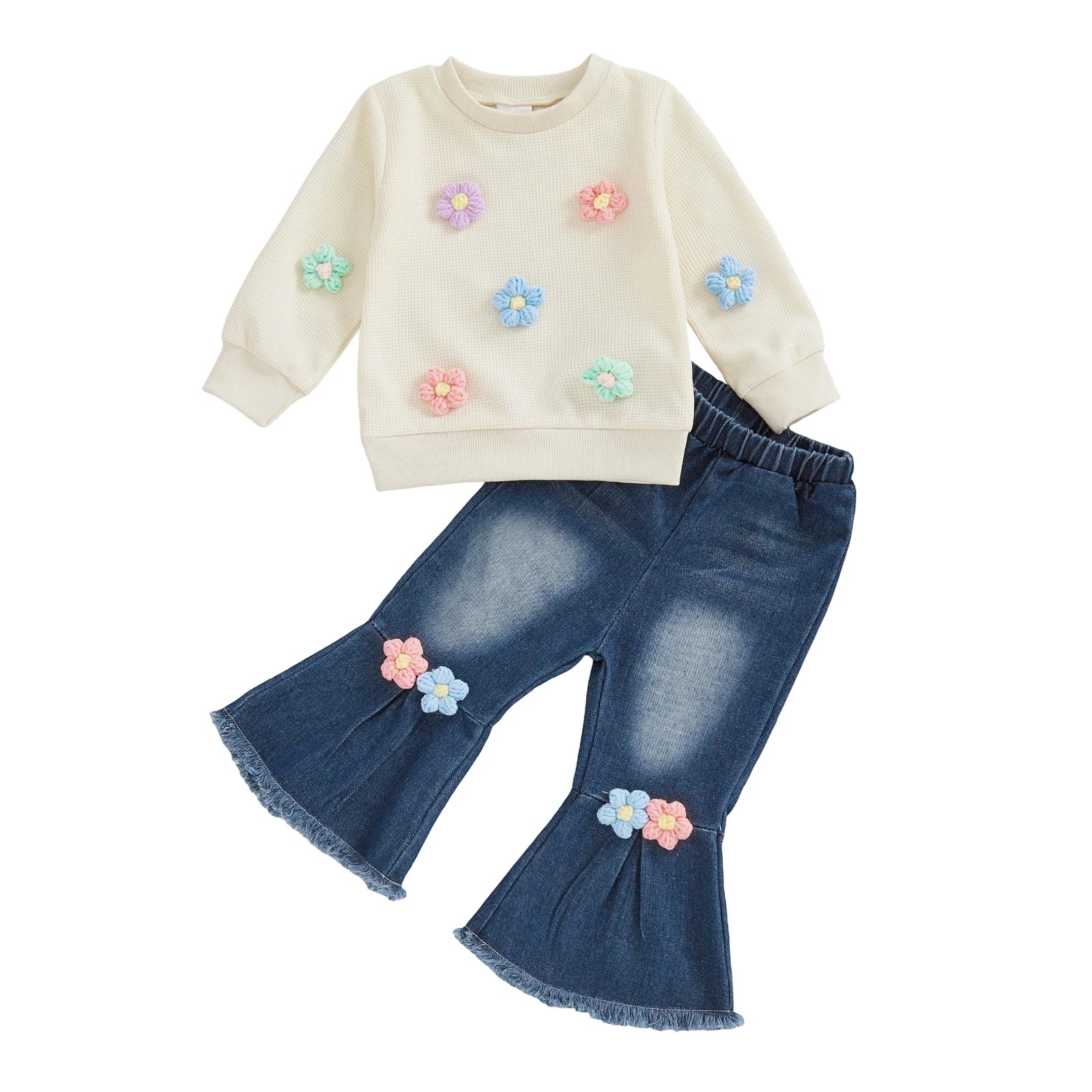 Children's outfit with floral top and denim pants on a white background