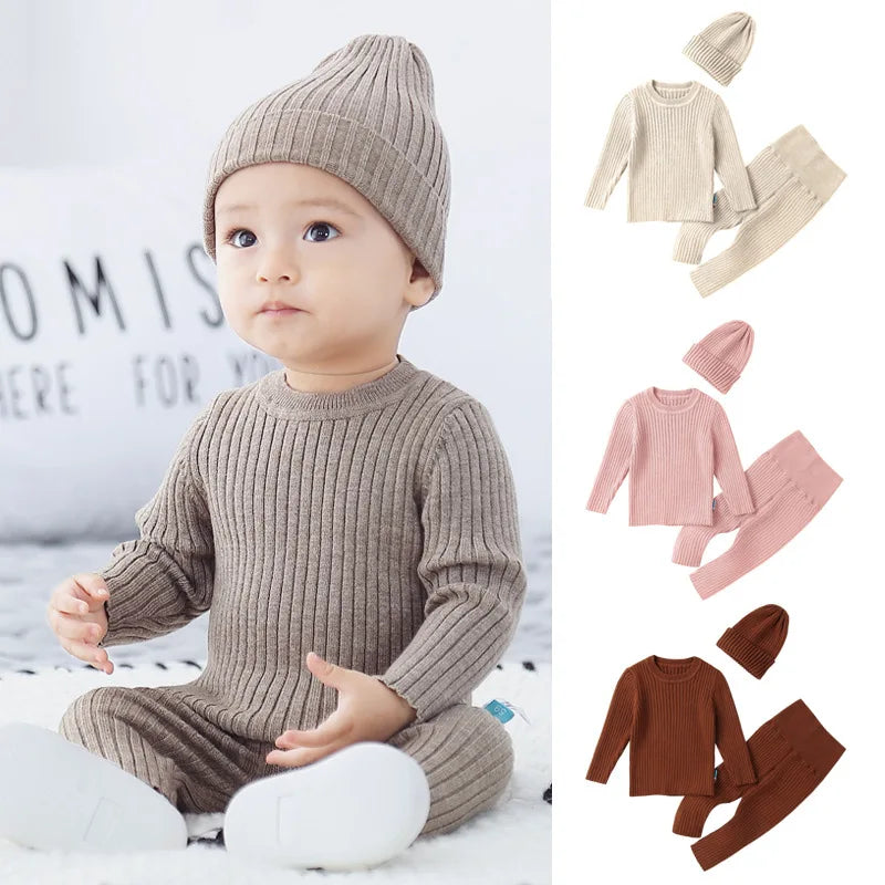 Baby wearing a brown ribbed outfit with matching hat, surrounded by other color options on a white background.