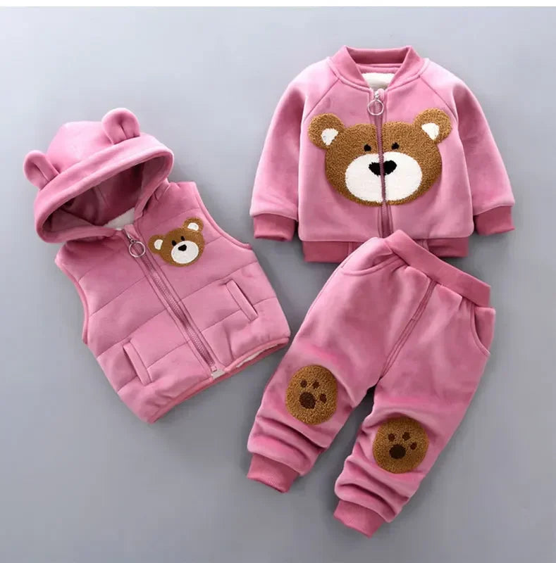 Pink children's hoodie, vest, and pants set with bear face designs on a gray background